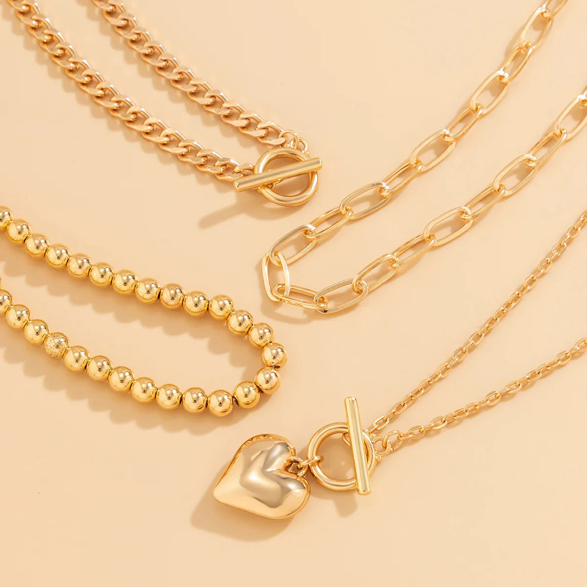 HeartGleam - 4 Piece Necklace Set with Gold Heart-Shaped Pendants